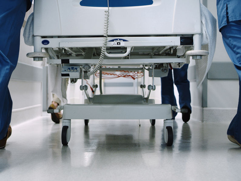 Medical Team Pushing A Hospital Bed