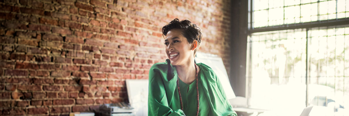 Businesswoman Looking Over Architecture Blueprints