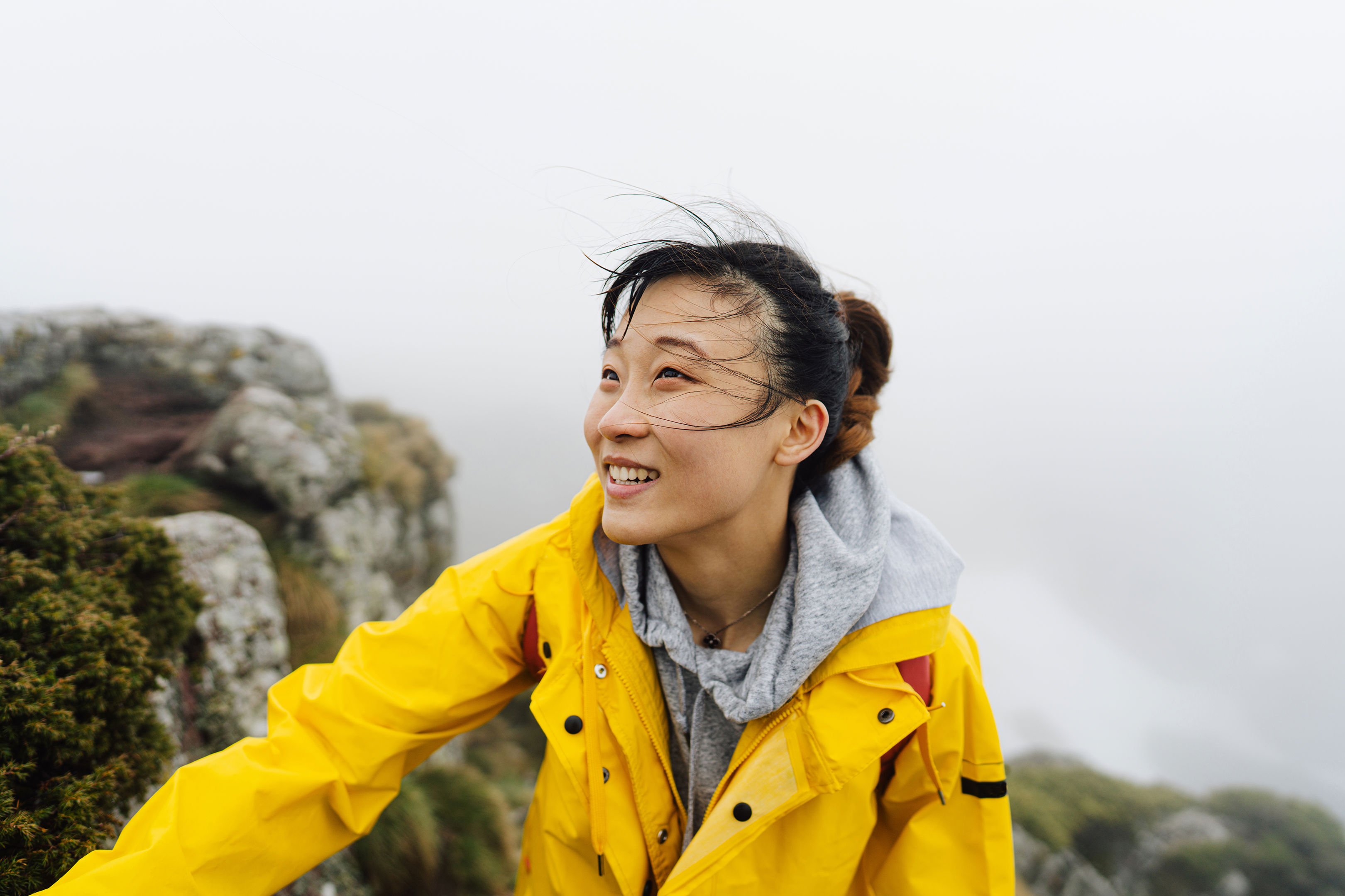 Woman Hiking A Foggy Mountain