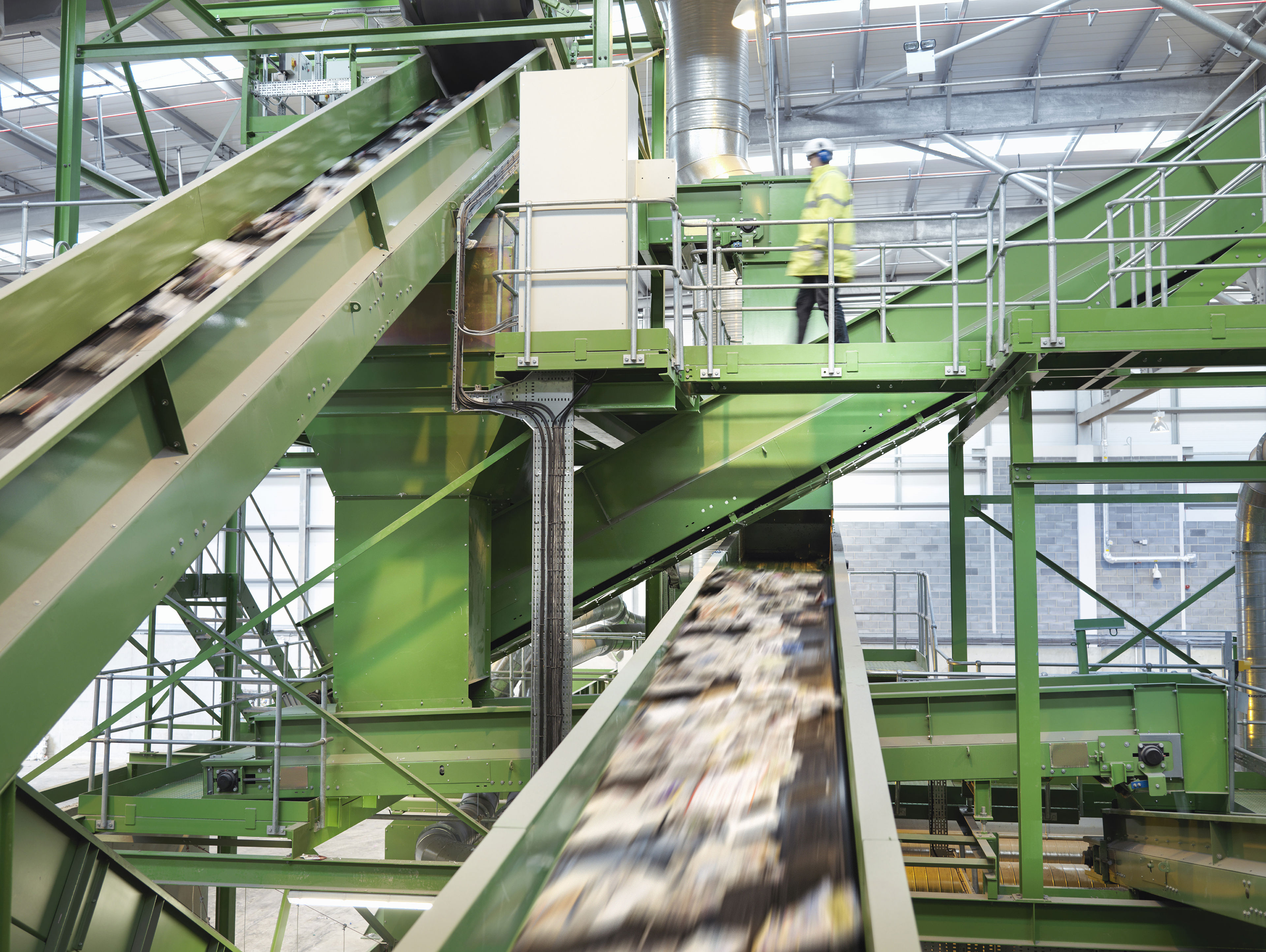 Worker Checking Conveyor Belts With Waste Paper In Waste Recycling Plant
