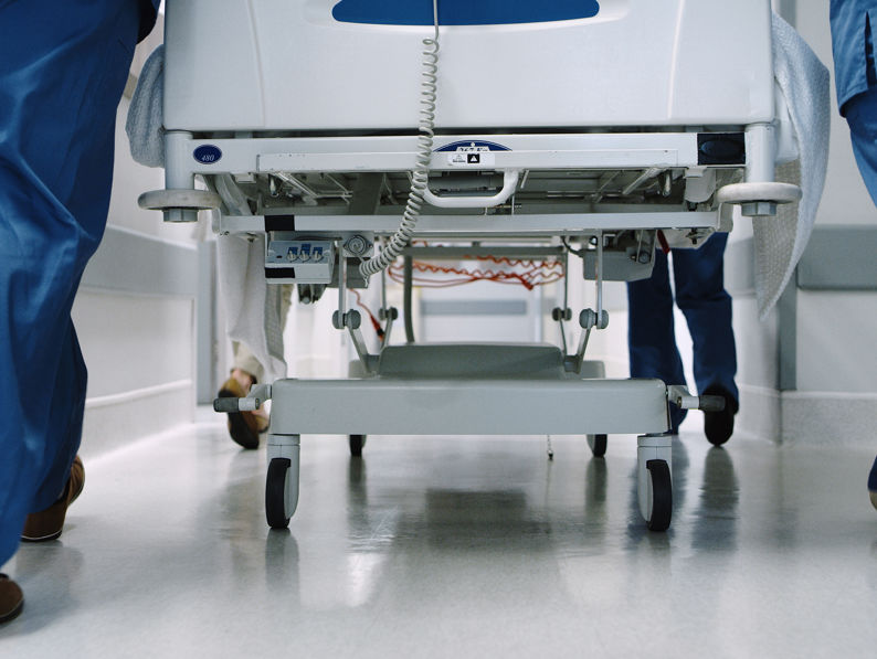 Medical Team Pushing A Hospital Bed