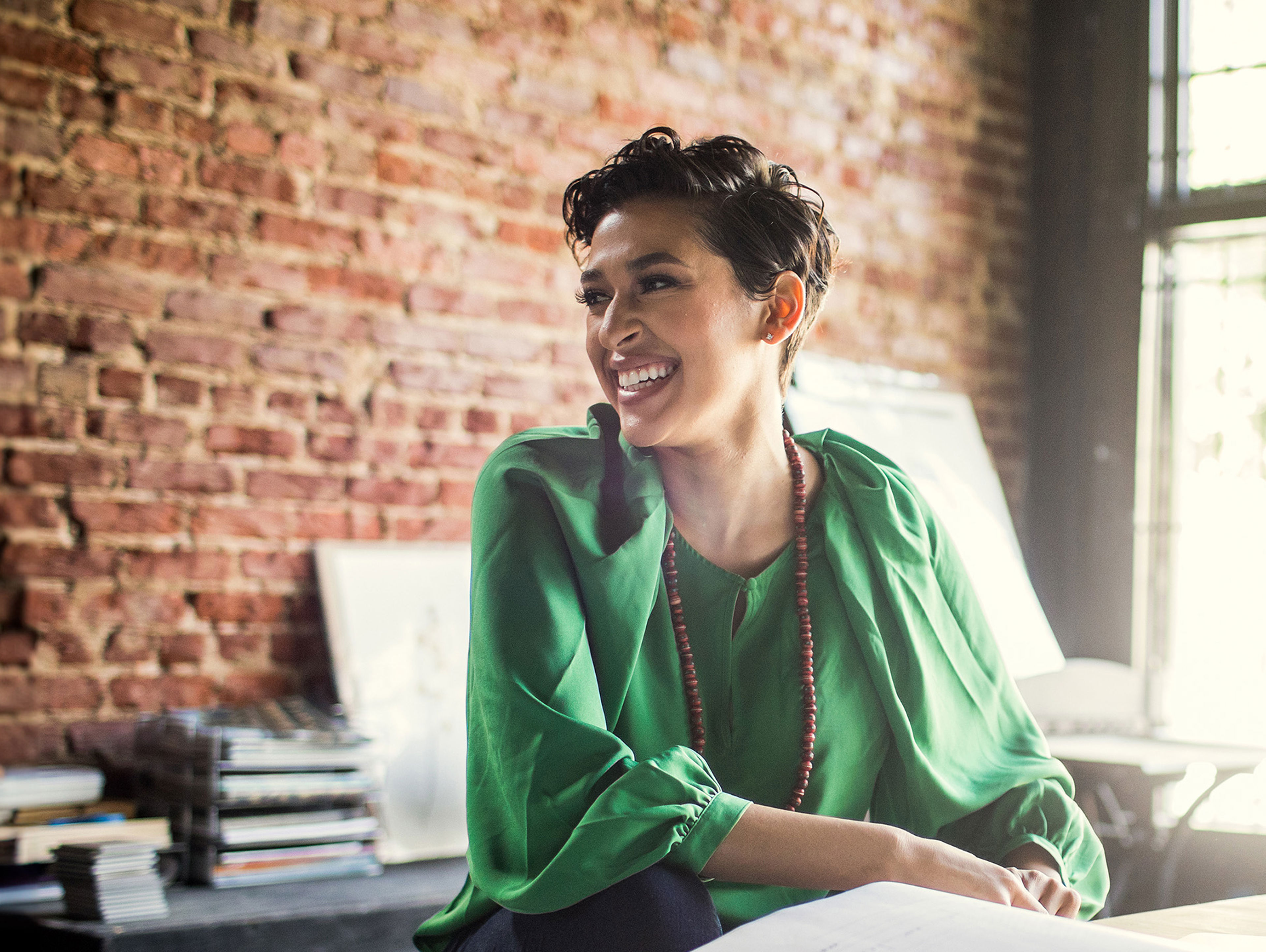 Businesswoman Looking Over Architecture Blueprints