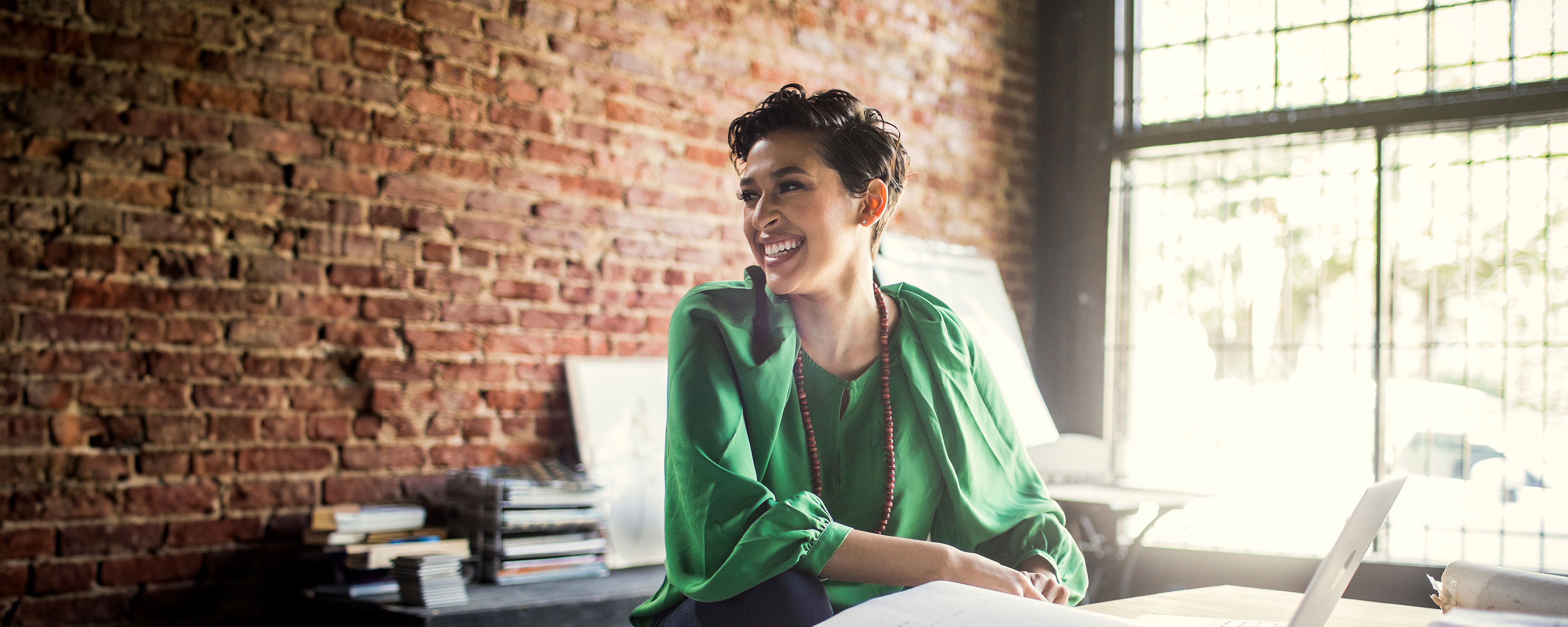 Businesswoman Looking Over Architecture Blueprints