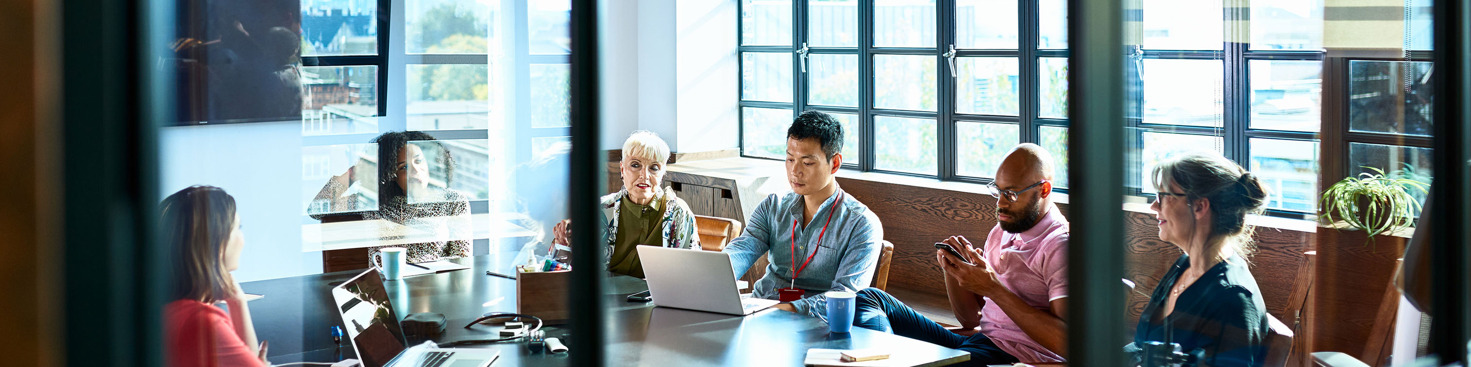 Looking Through Board Room Door At Business Strategy Meeting