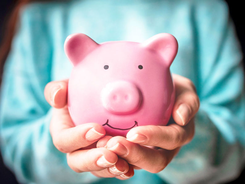 Holding Pink Piggy Bank