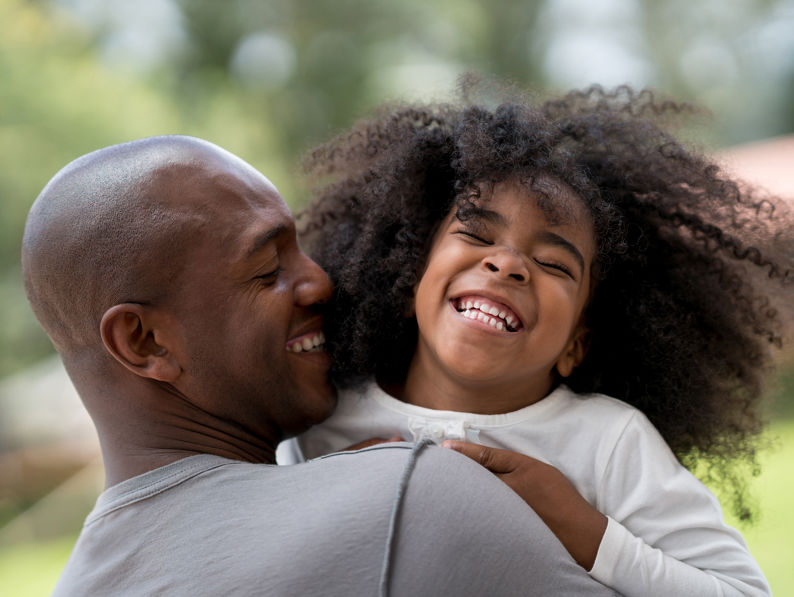 Happy Father Playing With His Daughter Outdoors