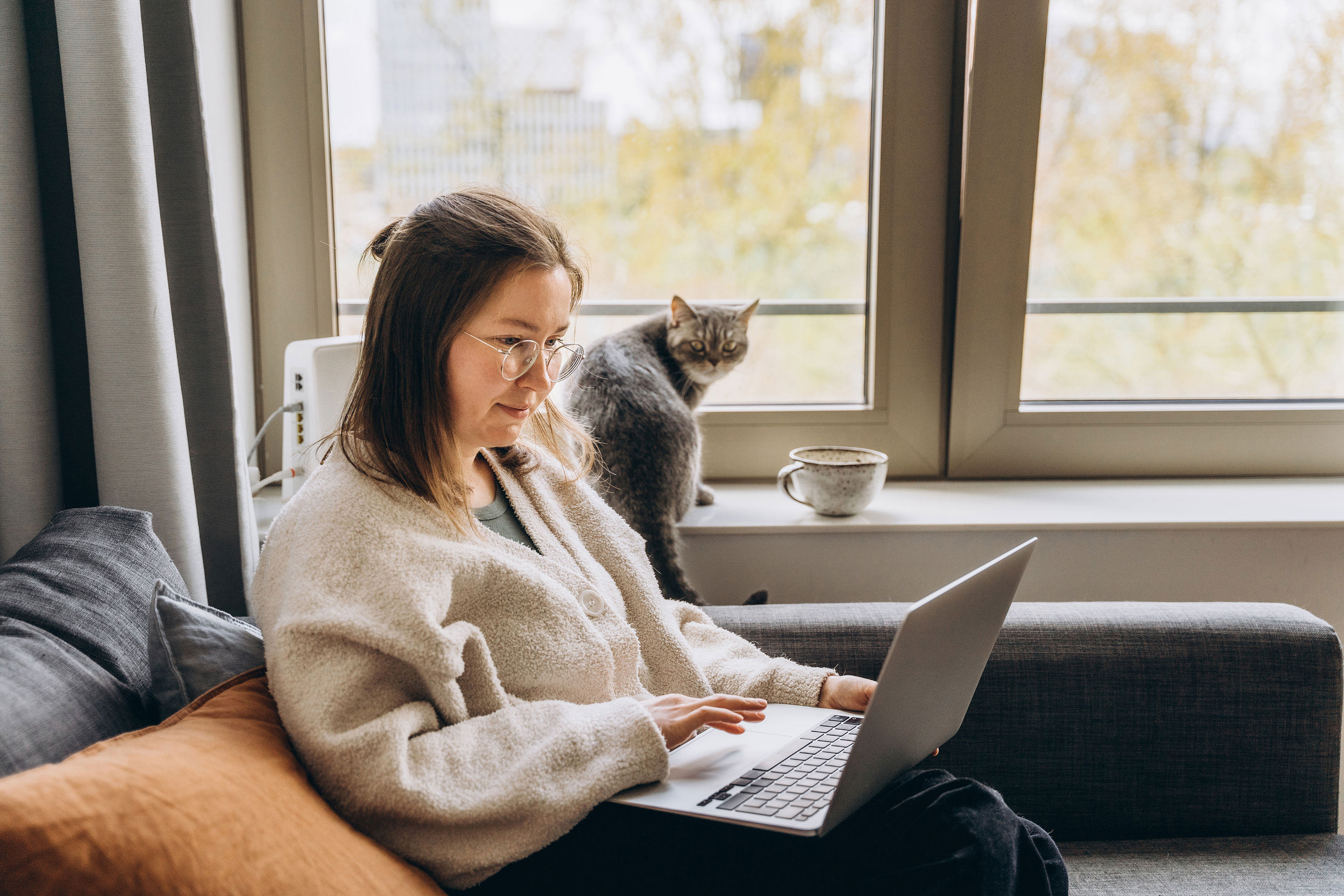 Young Woman Working At Home Remotely Using A Laptop