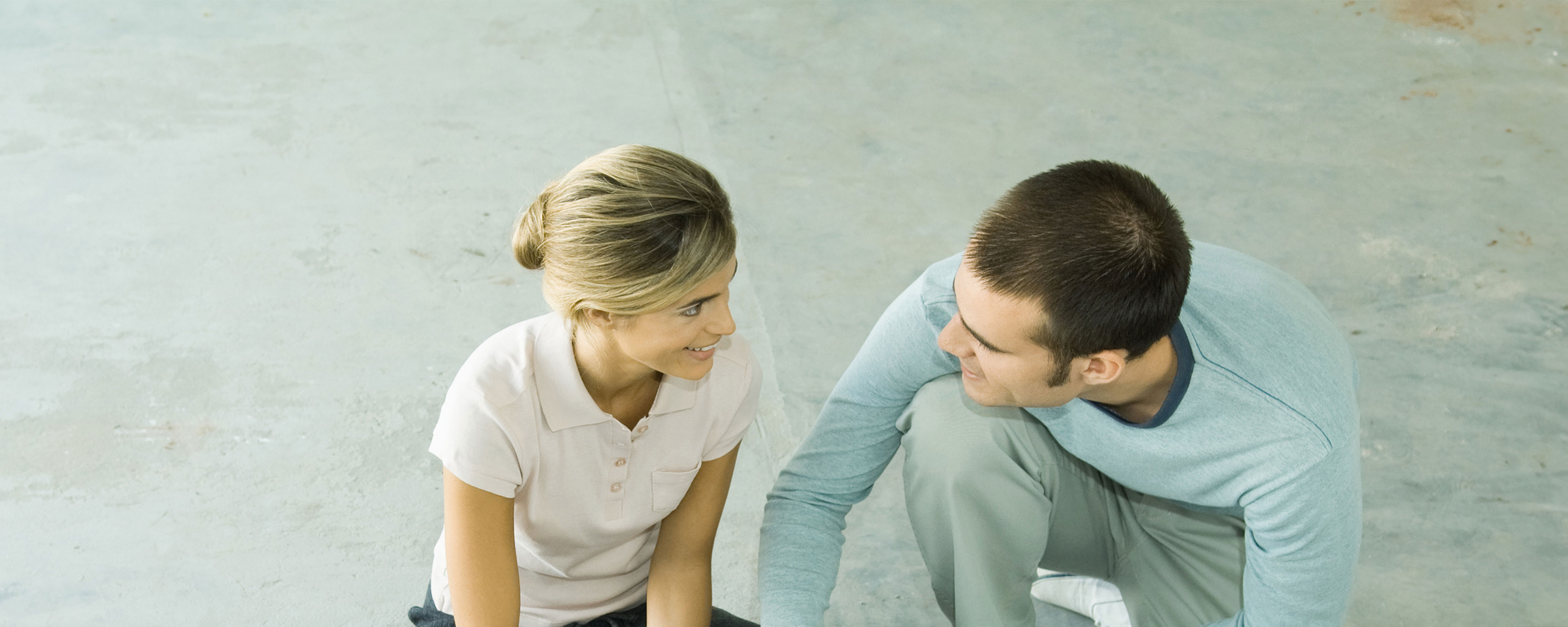 Couple Sitting On Floor Looking At Colour Swatches