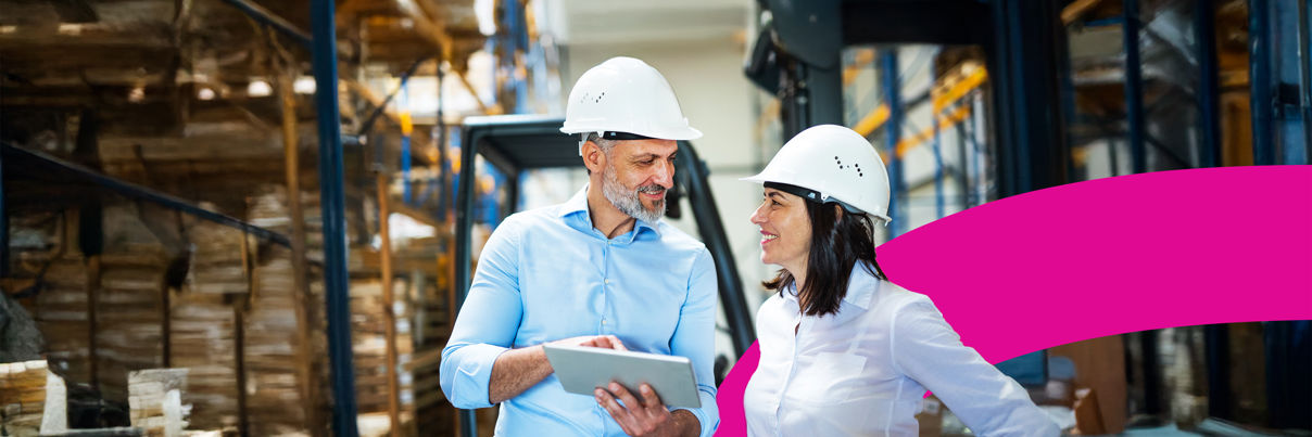 A man and woman wearing hard hats.