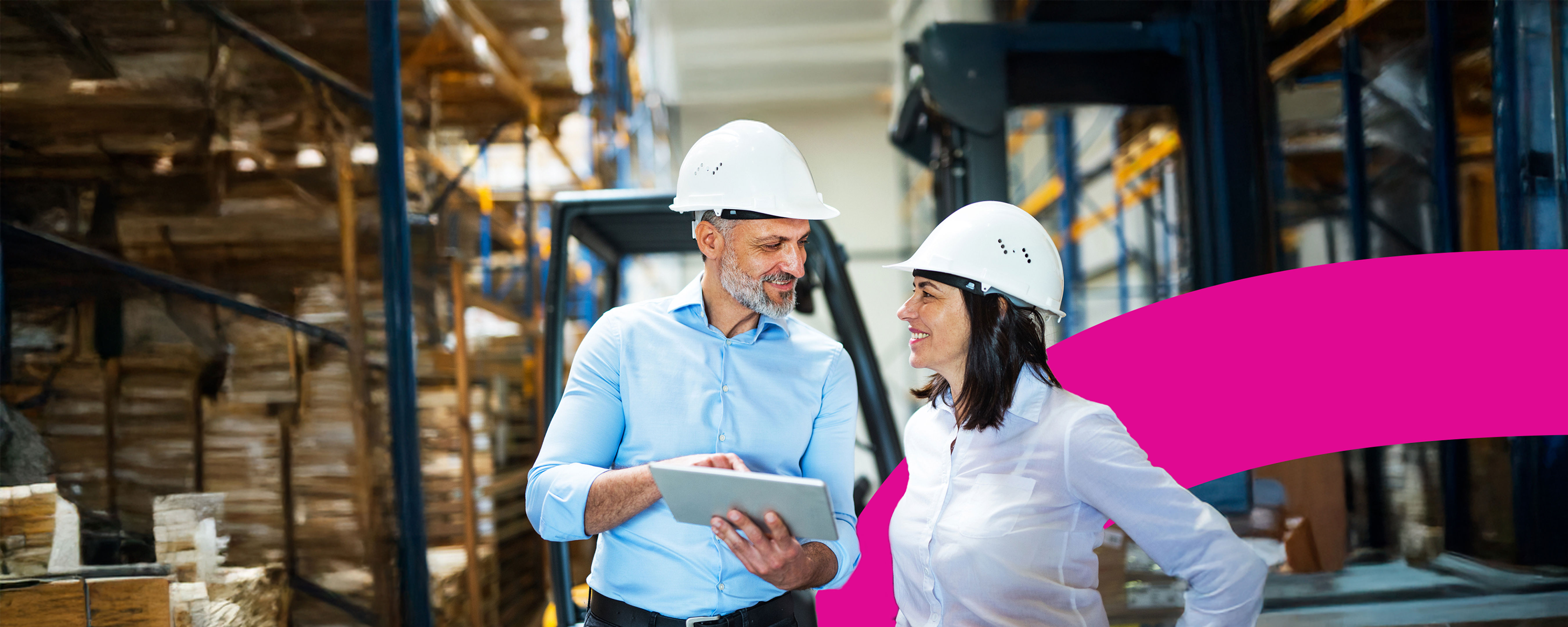 A man and woman wearing hard hats.