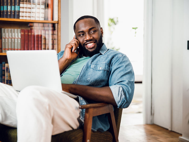 Smiling Man At Home With Gadgets