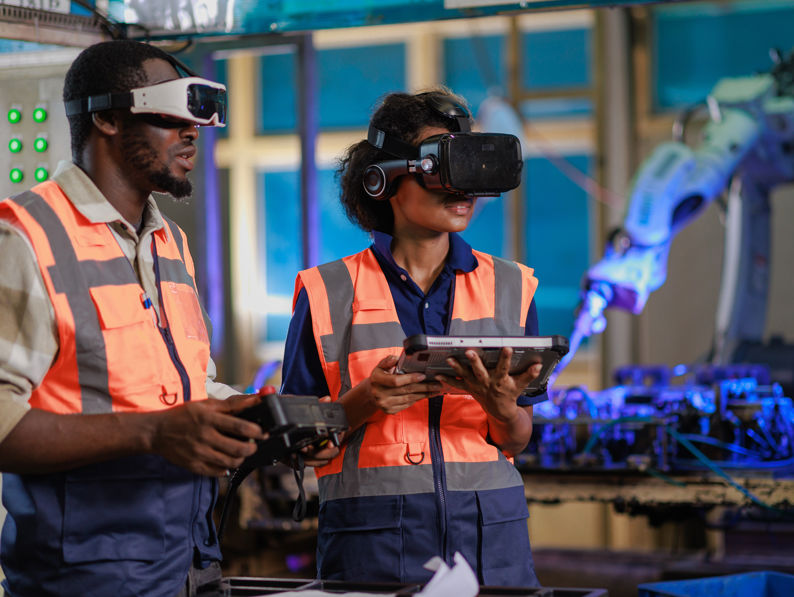 Engineer Using VR Glasses For Controlling A Robotic Welding Arm