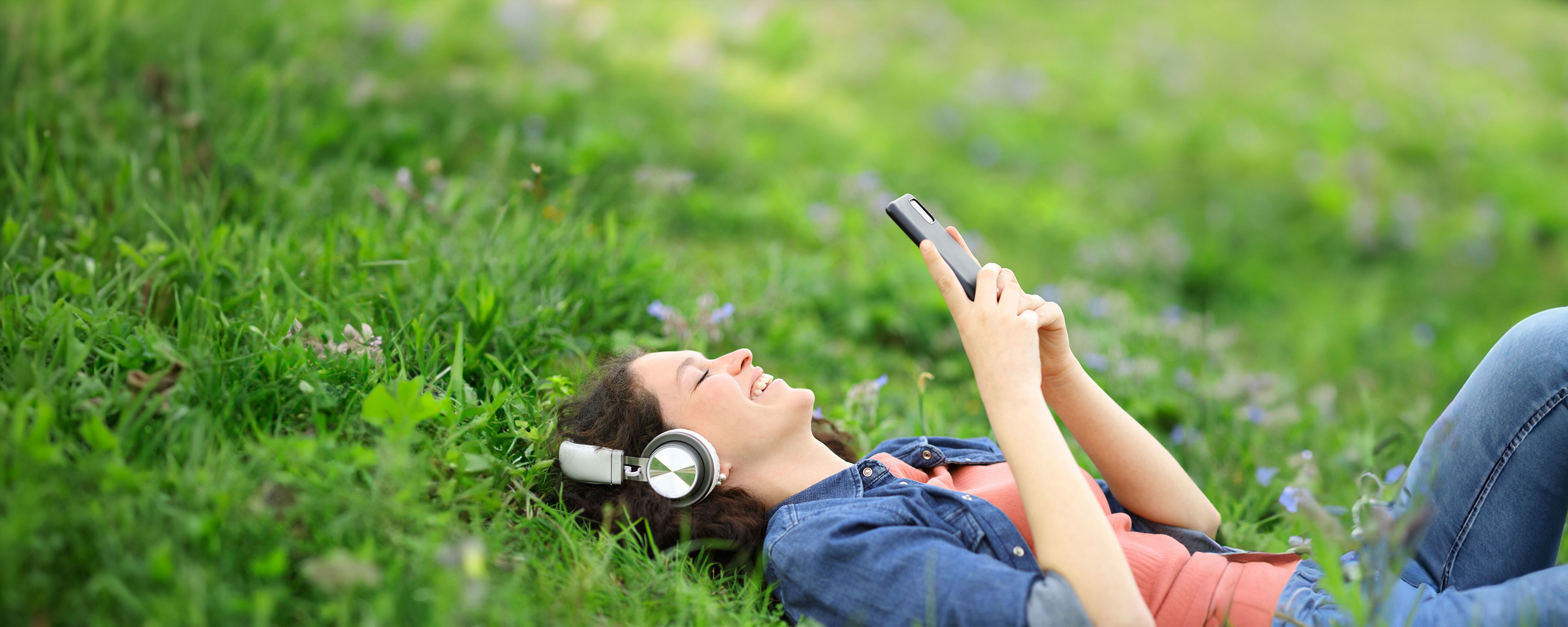 Happy Woman Listening With Headphones And Phone