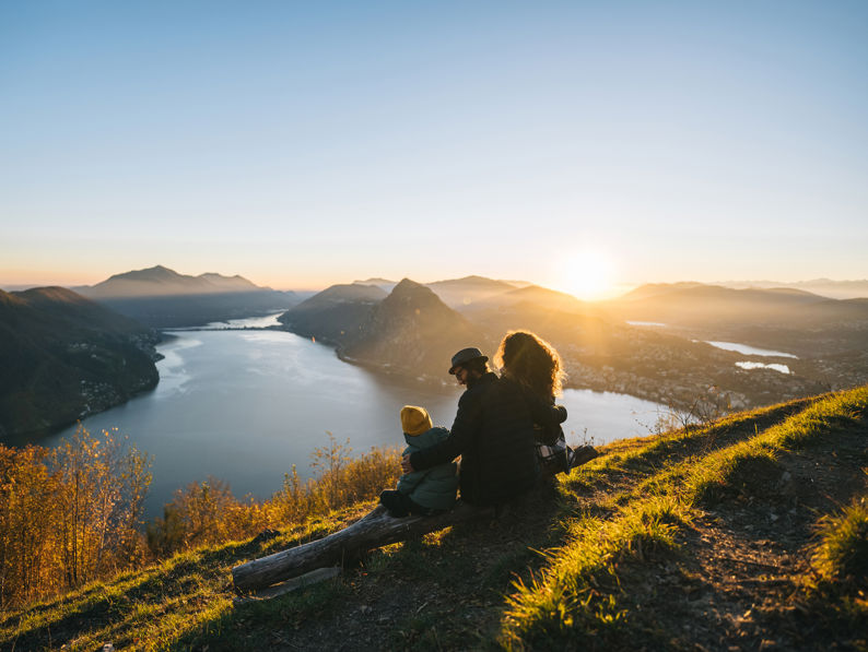 Family looking over water to mountains