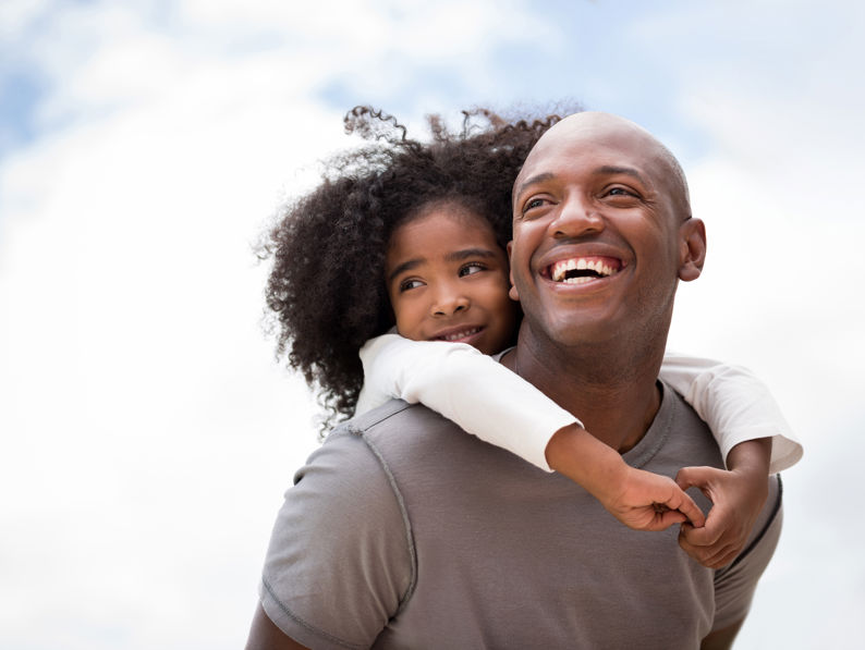 Father And Daughter Playing Outdoors