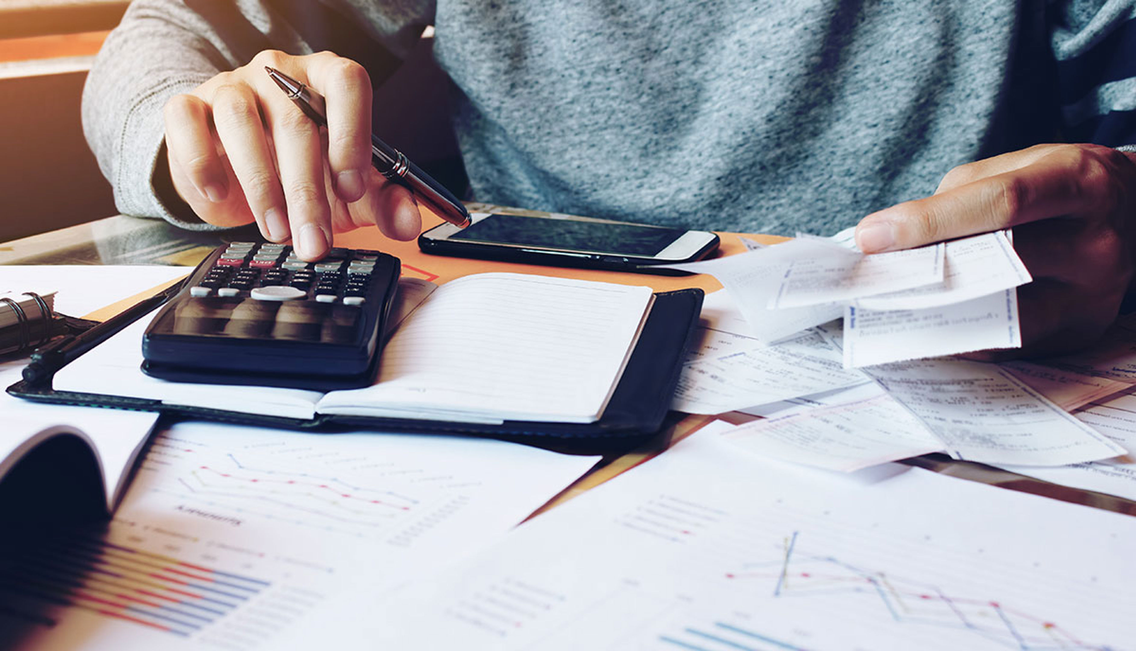 Man Using A Calculator