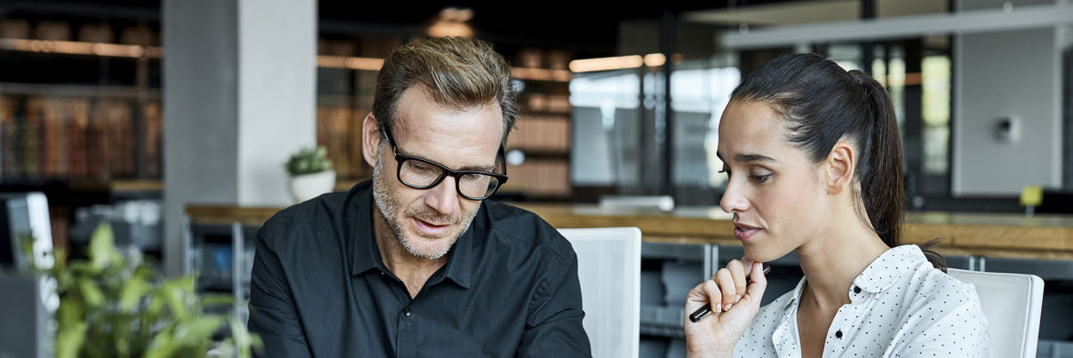 Colleagues Using Tablet PC In Textile Factory