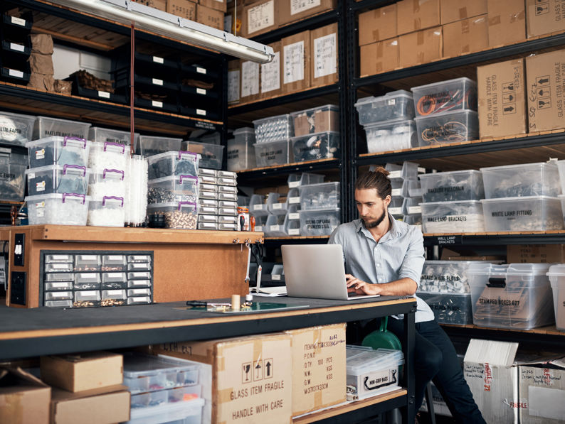 Man Using Laptop In A Workshop