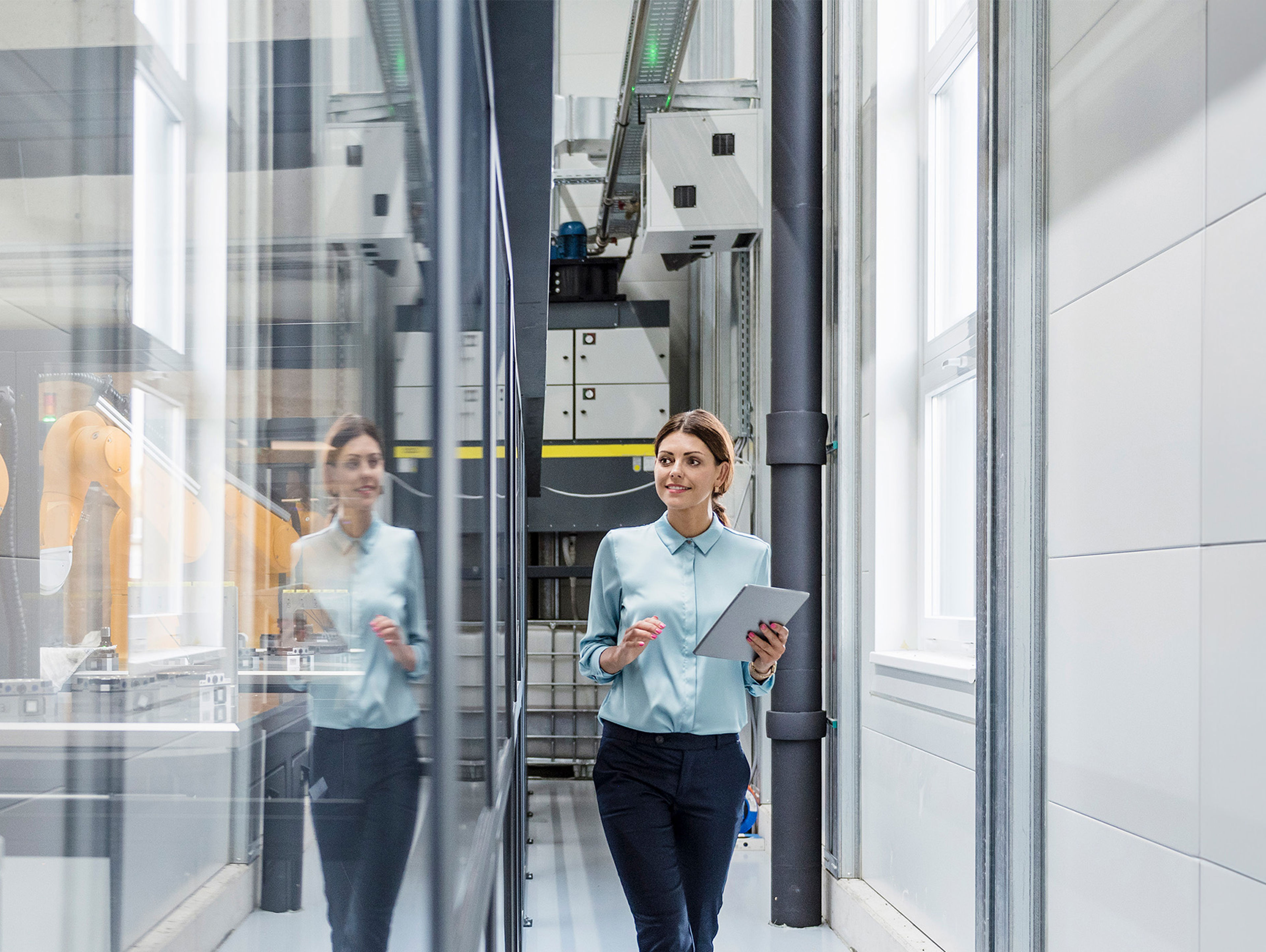 Businesswoman Checking Robots With Digital Tablet