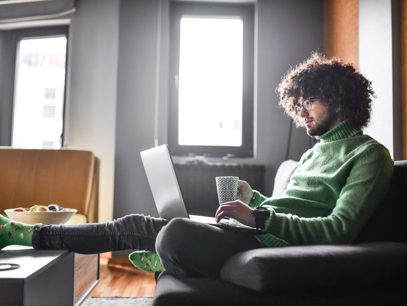 Male Relaxing And Waiting For Transaction While Drinking Coffee