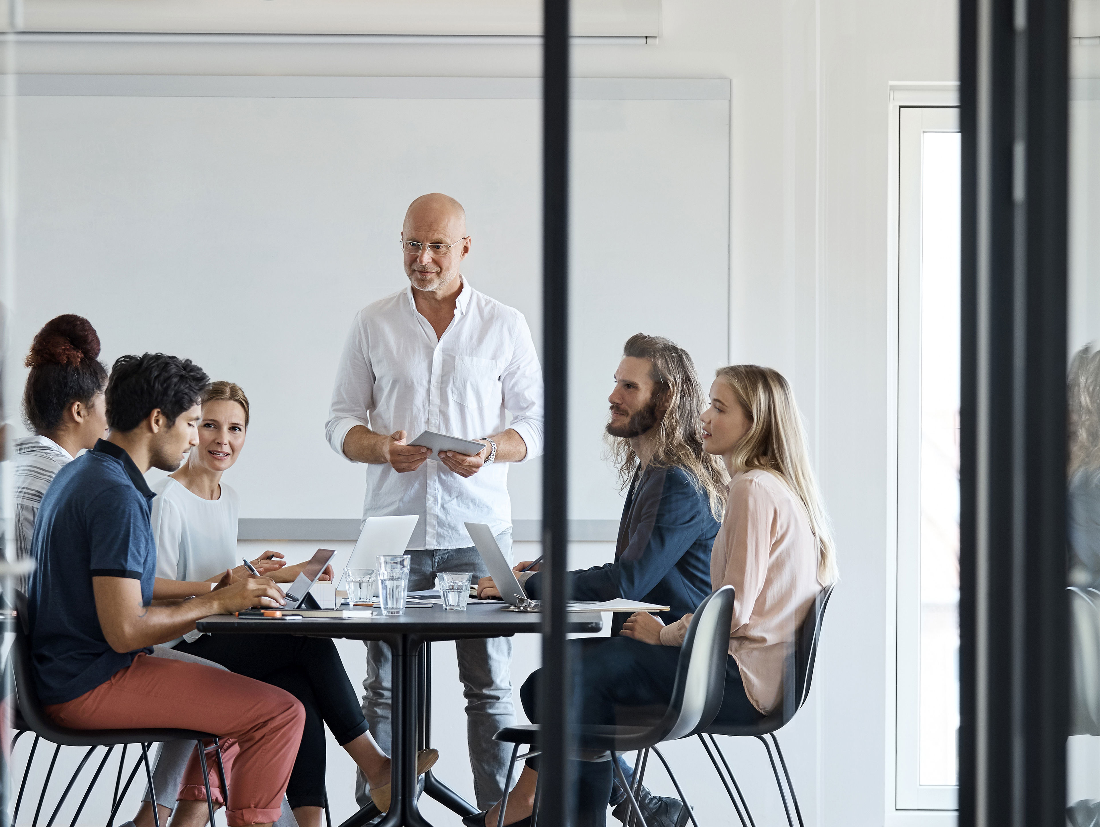 Executive Discussing With Professionals At Office