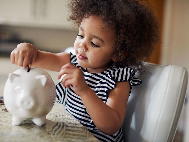 Child With Piggy Bank